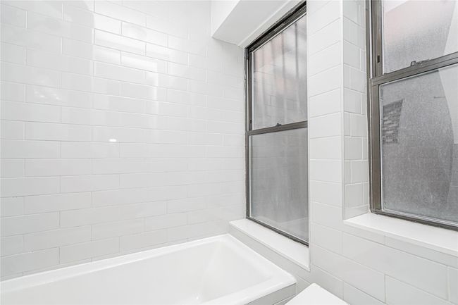 Bathroom with a tub to relax in and toilet | Image 18