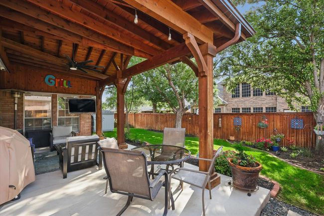 View of patio / terrace with outdoor dining area, a ceiling fan, a fenced backyard, grilling area, and outdoor lounge area | Image 31