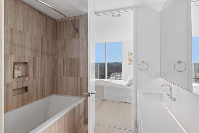 Ensuite bathroom with vanity, connected bathroom, bathtub / shower combination, and visible vents | Image 16
