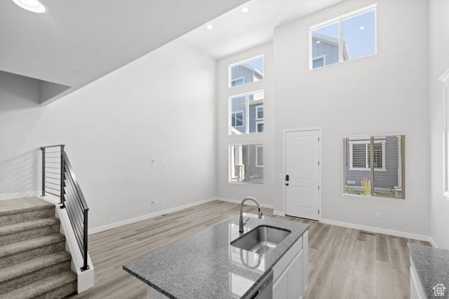 Foyer entrance with stairway, a high ceiling, light wood-style floors, and recessed lighting | Image 37