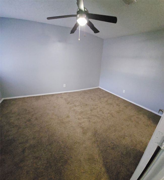 Spare room with ceiling fan and carpet floors | Image 16