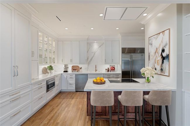 Beautifully renovated kitchen offers high end finishes, custom cabinetry and premium appliances. Image shown virtually staged. | Image 4