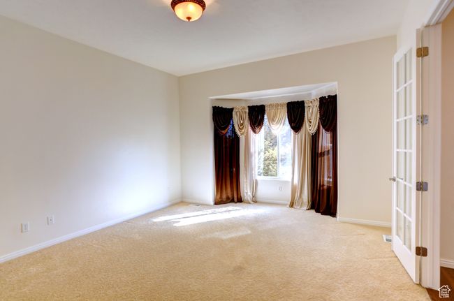 Unfurnished room featuring light carpet, french doors, and baseboards | Image 4