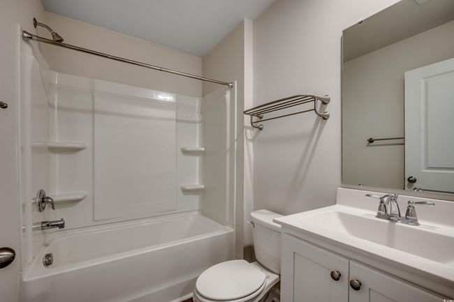 Full bathroom with shower combination, vanity, and toilet | Image 27