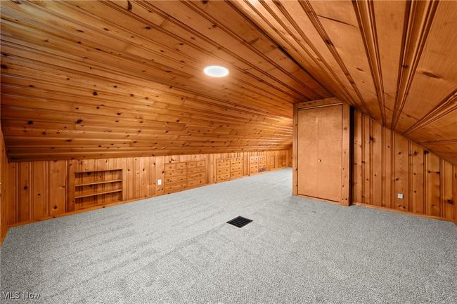 Additional living space with lofted ceiling, carpet, wooden walls, and wooden ceiling | Image 29