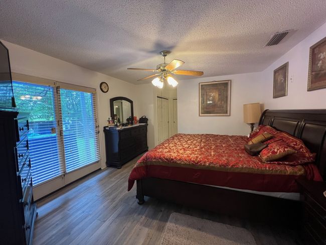 Bedroom featuring ceiling fan, and a textured ceiling | Image 9
