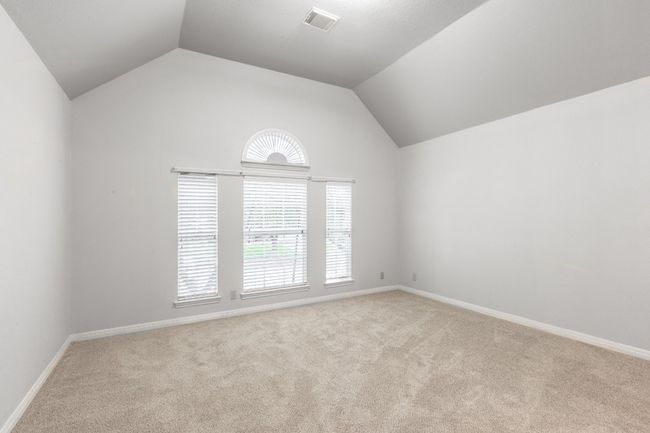 Spare room with carpet floors, lofted ceiling, plenty of natural light, and baseboards | Image 38