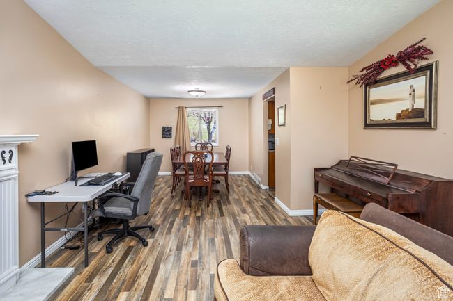 Office area with baseboards, wood finished floors, and a textured ceiling | Image 5