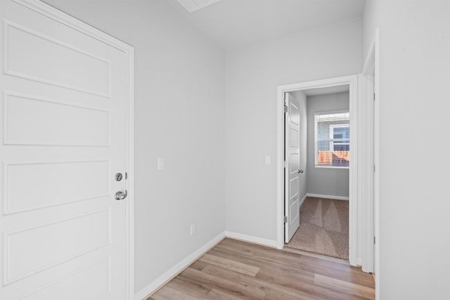 Hallway with light wood-type flooring and baseboards | Image 15