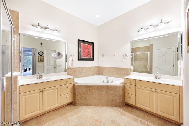 Bathroom with double vanity, tile flooring, and independent shower and bath | Image 21