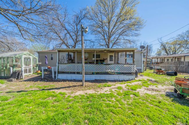 Rear view of house with an outbuilding, an exterior structure, a yard, and fence | Image 19