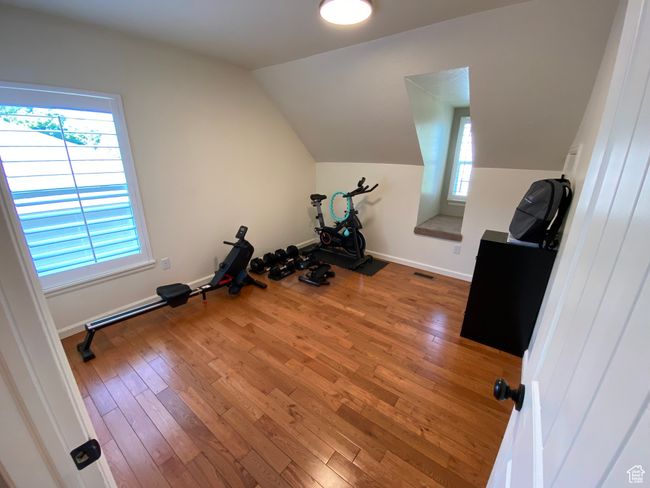 Workout area featuring hardwood / wood-style floors, lofted ceiling, and baseboards | Image 21