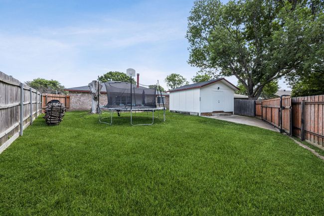 Fenced backyard with rear entry from the alley. | Image 25