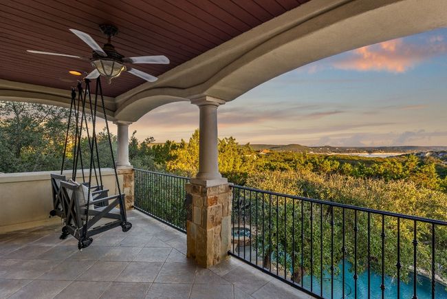 Relax on the second floor balcony with the gorgeous view of Lake Travis at dusk. | Image 22