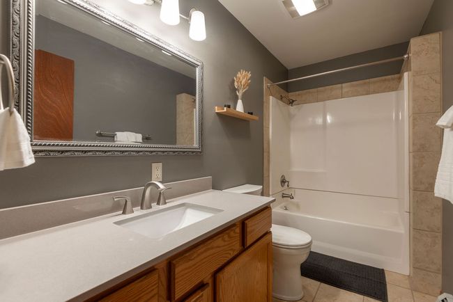 Full bath featuring tile patterned flooring, vanity, and shower combination | Image 18