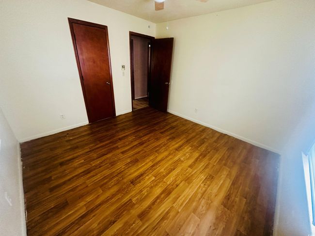 Unfurnished room featuring wood finished floors, a ceiling fan, and baseboards | Image 17