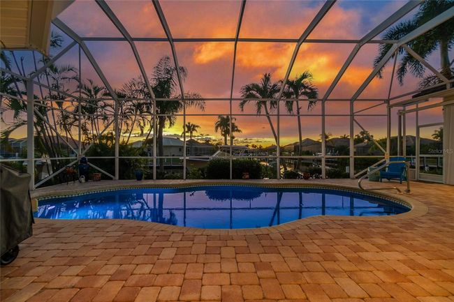 Brick pavers surrounds the pool and covered area for having your evening cocktail | Image 20