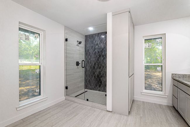 Bathroom with vanity, a shower stall, and baseboards | Image 24