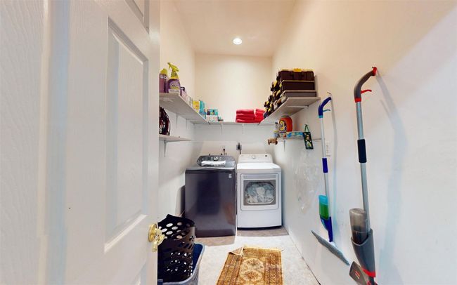 Washroom with washing machine and clothes dryer and recessed lighting | Image 34