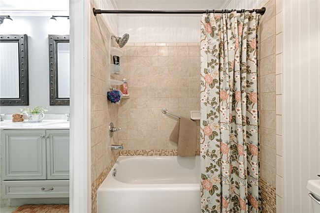 Bathroom with vanity and shower / bathtub combination with curtain | Image 31