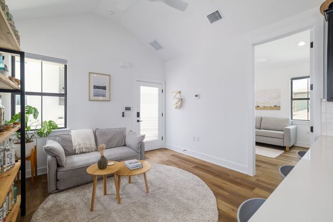 Garage apartment living room featuring lofted ceiling and white oak wood floors | Image 24