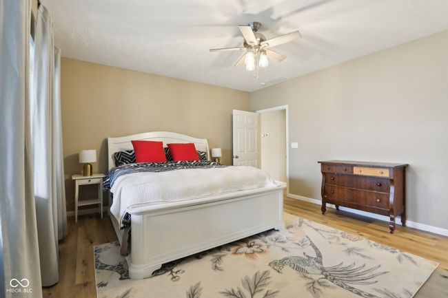 bedroom featuring baseboards, ceiling fan, and light wood-style flooring | Image 44