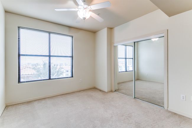Secondary bedroom with ceiling fan and large window with beautiful view. | Image 10