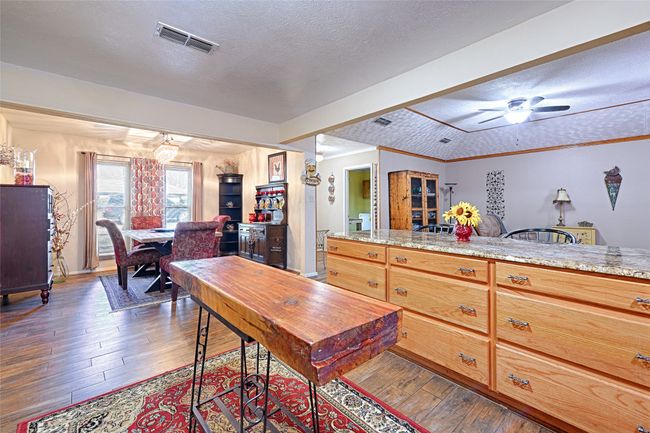 Kitchen with ceiling fan, dark hardwood / wood-style floors, and a textured ceiling | Image 19