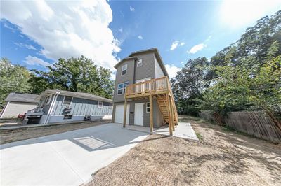 View of front of home featuring a wooden deck and a garage | Image 3