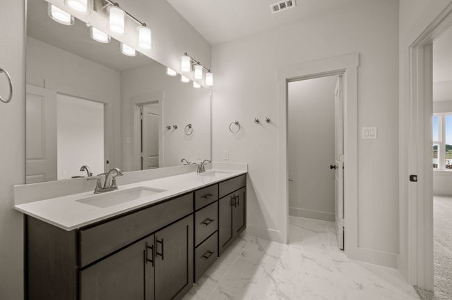 You'll find ample room for two in this stylish owner's bath! | Image 12