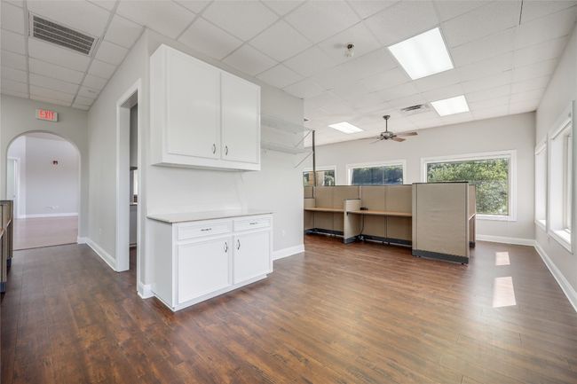 Kitchen featuring dark wood-style floors, visible vents, arched walkways, a paneled ceiling, and ceiling fan | Image 17