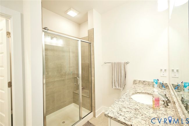 Full bathroom featuring a stall shower and vanity | Image 11