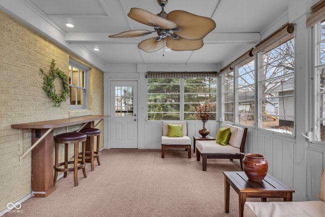 sunroom / solarium featuring a wealth of natural light, outdoor dry bar, and ceiling fan | Image 26