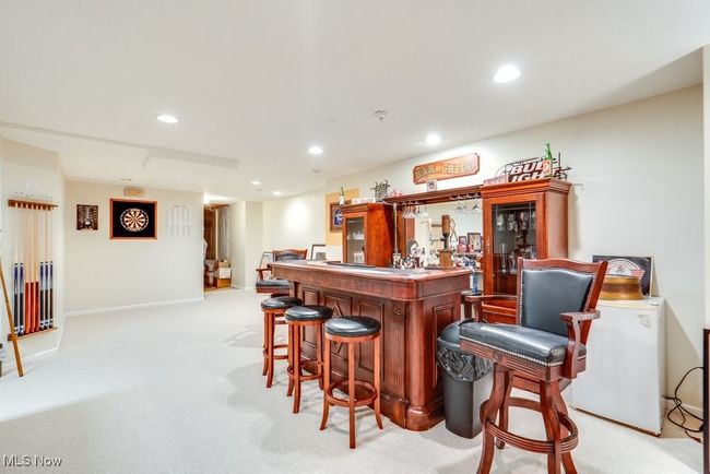 Indoor dry bar with light colored carpet and recessed lighting | Image 35