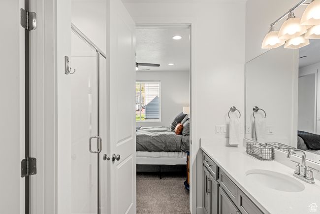 Ensuite bathroom with vanity, ensuite bath, recessed lighting, a stall shower, and a textured ceiling | Image 15
