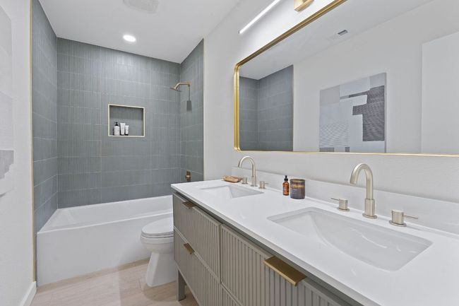 Bathroom featuring wood finished floors, double vanity, and shower combination | Image 16