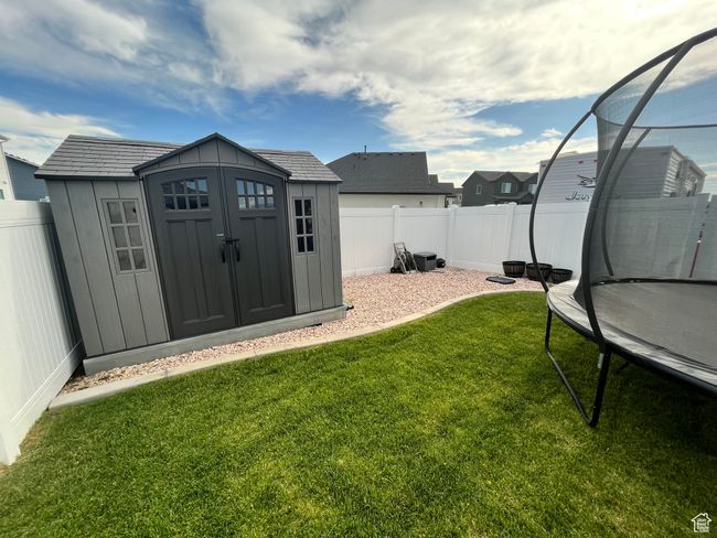 View of yard featuring a trampoline | Image 30