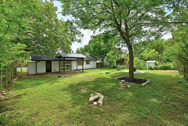 Fenced yard with a patio | Image 25