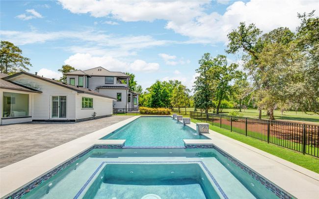 The stunning custom 65-foot lappool with spa is surrounded by aspacious patio and overlooks the5th hole on the ChampionsCypress golf course. | Image 4