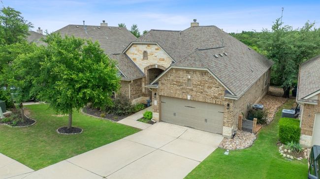 Front facade featuring driveway, a chimney, a front lawn, a garage, and brick siding | Image 39