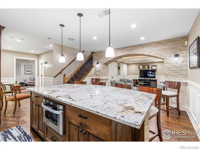 Large Granite Island. Stone Archway opens to the Recreation/Media room. | Image 27