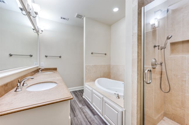 Full bath with a shower stall, a garden tub, double vanity, and wood finished floors | Image 12