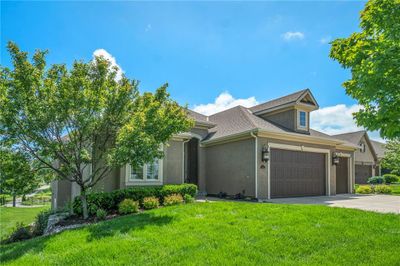 View of front of property featuring a front yard and a garage | Image 3