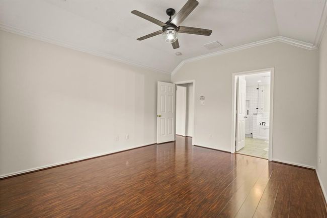 Primary bedroom featuring a private ensuite bathroom. | Image 11