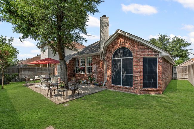 Rear view of property featuring brick siding, a patio area, and a chimney | Image 21