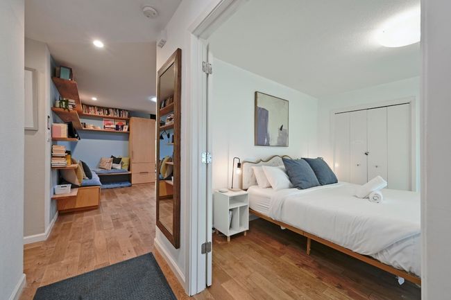 The entryway continues into the centrally located living room, with the other bedrooms in the hallway to the left. | Image 30