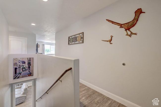 Corridor featuring baseboards, an upstairs landing, light wood finished floors, and recessed lighting | Image 7