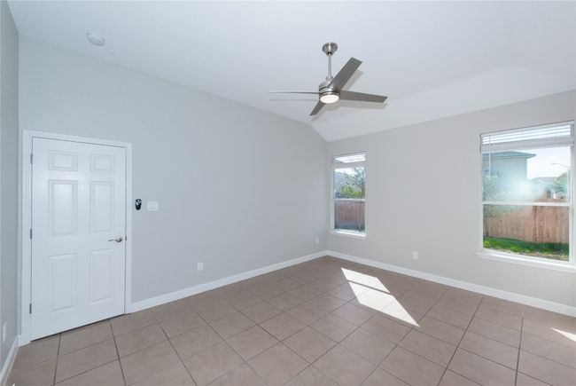 door on left is entrance to primary bedroom showing other side of the room | Image 11