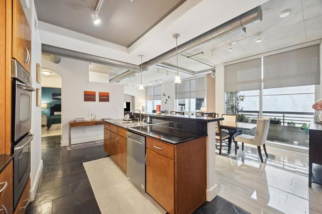 Another perspective from the kitchen showcases the private views and spacious flow into the dining and living areas. | Image 6