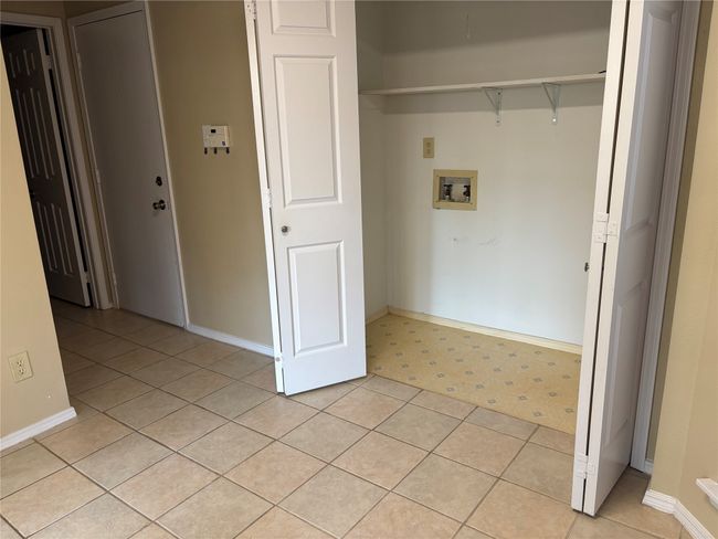 Laundry room featuring light tile patterned floors, baseboards, laundry area, and hookup for a washing machine | Image 11